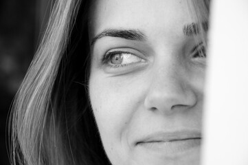 woman smile with beautiful eyes, closeup. black and white portrait. Delicate girl face adorned with...