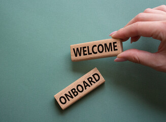 Welcome onboard symbol. Concept words Welcome onboard on wooden blocks. Beautiful grey green...