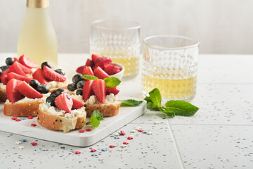 American flag sandwich with strawberries, blueberries, whipped sweet cream, soft cheese on toast bread. 4th of July American Independence Day food. Independence or Patriotic Day breakfast idea Mock up