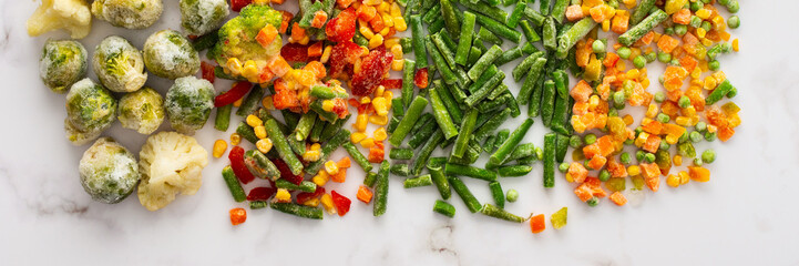 Frozen vegetable mix banner, frozen green beans and broccoli, corn and carrots, brussels sprouts and cauliflower, peas and bell peppers, copy space, top view