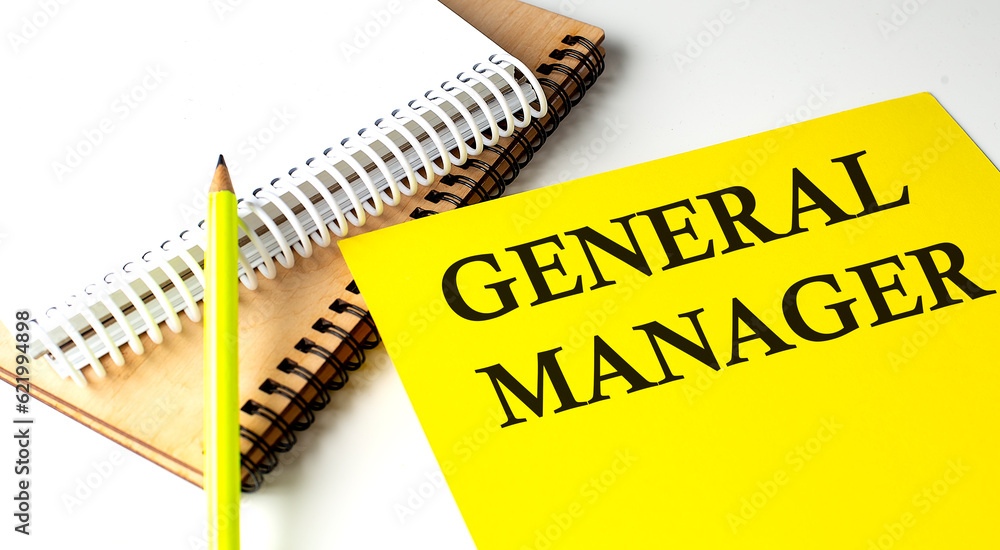 Poster general manager text written on a yellow paper with notebook