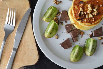 cheese pancakes on a white plate and cutlery