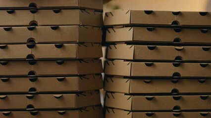 Background of cardboard boxes for pizza, smooth camera movement Pile of pizza boxes on the background of a pizzeria bakery industrial pizzeria takeaway food customer service diner

