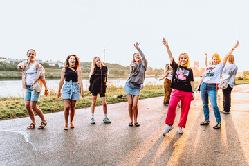 Obraz premium dancing cheerful attractive women at sunset. 