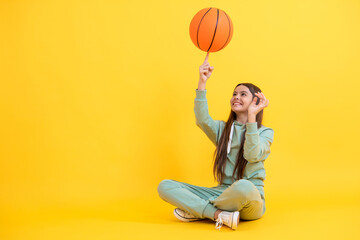 Teen girl excelling in basketball. Skilled teen girl playing the basketball. Competitive teen girl...