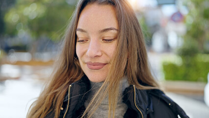 Young caucasian woman smiling confident looking down at park