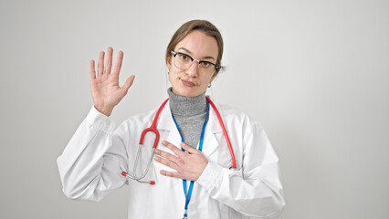 Young caucasian woman doctor making an oath with hand on chest over isolated white background