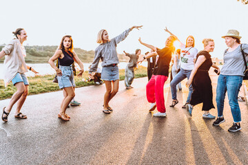Obraz premium dancing cheerful attractive women at sunset. 