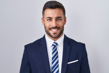 Handsome hispanic man wearing suit and tie with a happy and cool smile on face. lucky person. - obrazy, fototapety, plakaty