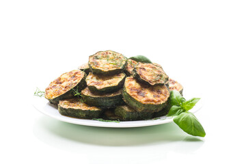 zucchini fried in circles with spices and herbs, in a plate .