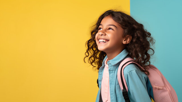 Portrait of smiling schoolgirl with school bag isolated on yellow background. Back to school concept. AI Generated.
