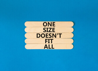 One size does not fit all symbol. Concept words One size does not fit all on wooden stick. Beautiful blue table blue background. One size does not fit all business concept. Copy space.