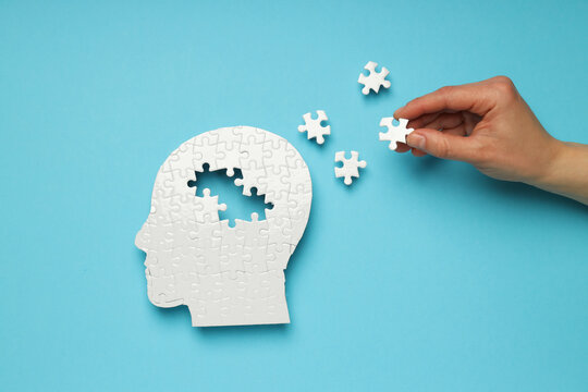 Puzzle head with missing elements on a blue background