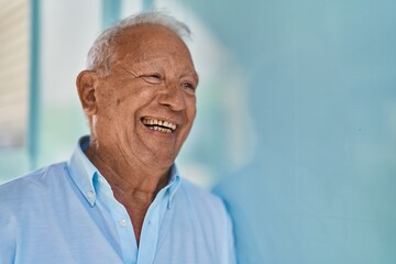 Senior grey-haired man smiling confident standing at street