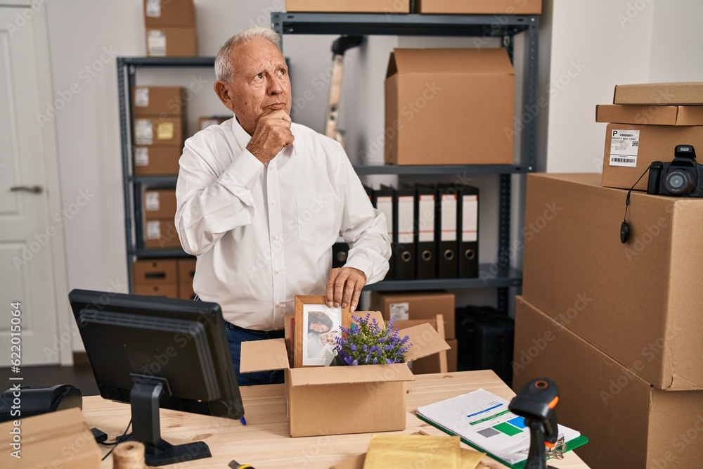 Canvas Prints Senior man with grey hair working at small business ecommerce serious face thinking about question with hand on chin, thoughtful about confusing idea