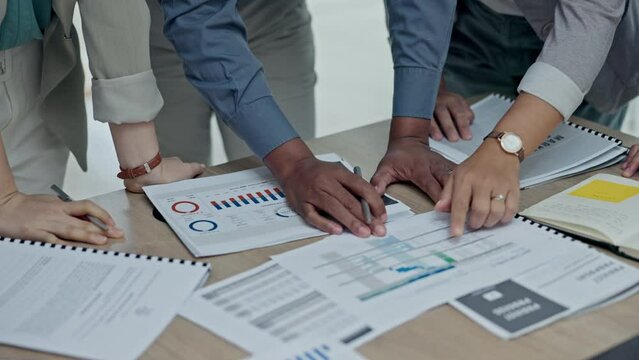Business people, hands and writing on documents in meeting, planning or marketing strategy on office desk. Group working on paperwork in teamwork for project plan, statistics or proposal at workplace