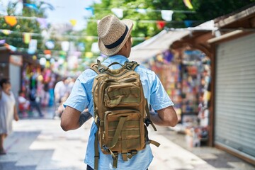 African american man tourist walking on back view at street market