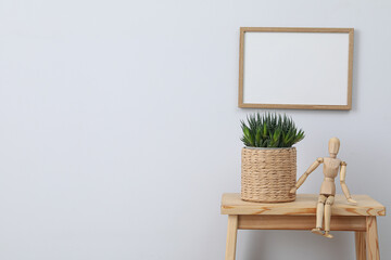 Photo frame on the wall near the table with decor