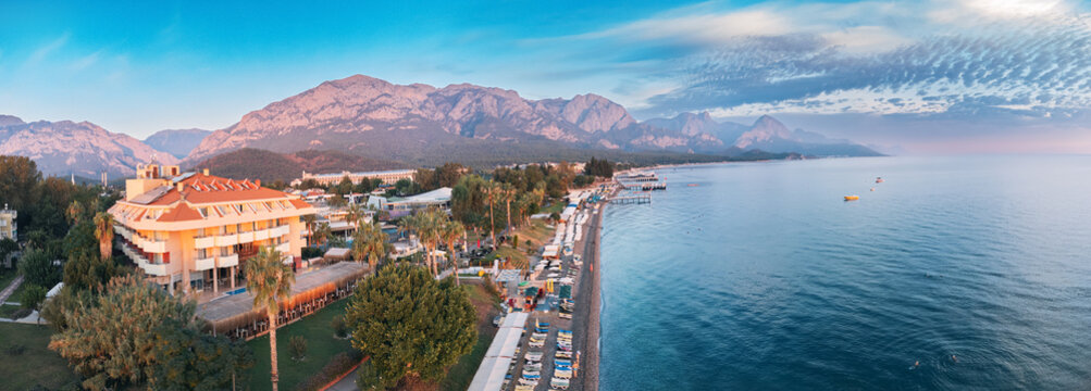 Aerial sunrise view of Kemer resort town, Turkey's coastal charm with breathtaking aerial image showcasing its scenic landscapes and vibrant blue waters.
