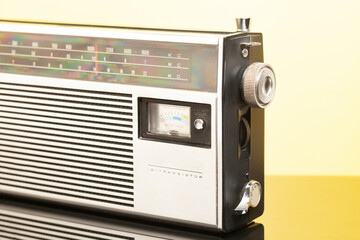 Vintage transistor radio, on yellow background