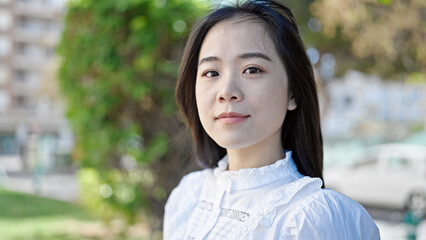 Young chinese woman smiling confident looking to the side at park