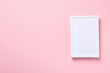 White photo frame on a pink background