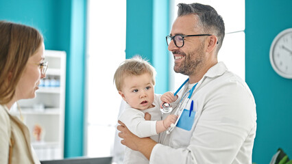 Fototapeta premium Caucasian mother with baby on a doctor appointment at clinic