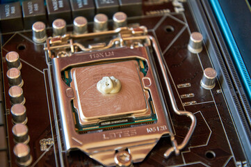 applying thermal paste to the central processor of the motherboard close up