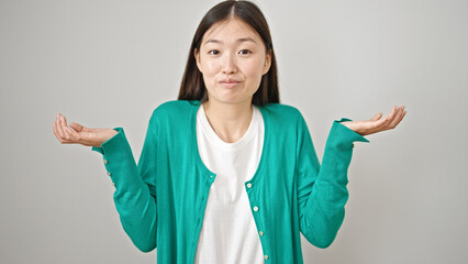 Young chinese woman standing clueless over isolated white background