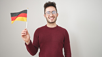 Young hispanic man smiling confident holding deutschland flag over isolated white background