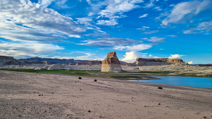 Panoramic view on solitary rock formations Lone Rock in Wahweap Bay in Lake Powell in Glen Canyon Recreation Area, Page, Utah, USA. Road trip to sand beach on wild campground in sunny summer. Vacay