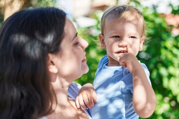 Mother and son smiling confident standing at park