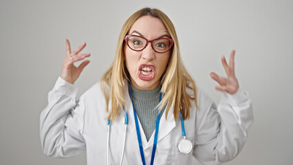 Young blonde woman doctor angry and stressed over isolated white background