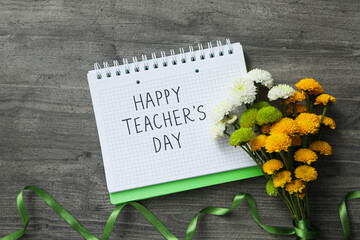 Naklejka premium The inscription of congratulations on a notepad on the occasion of Teacher's Day