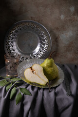 Still life with pears on the old metal plate. Close up - 622028204