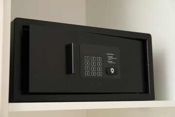 Black safe on shelves in the apartment