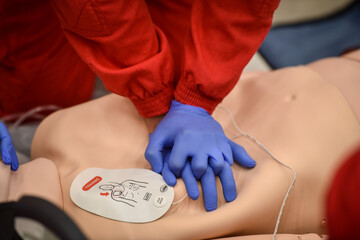 Paramedics simulate emergency intervention on medical training manikin - 622031079