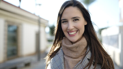 Beautiful hispanic woman smiling confident at street