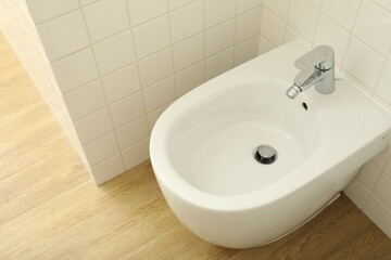 Close-up of a white bidet in a bathtub