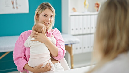 Mother and daughter hugging each other having medical consultation at clinic