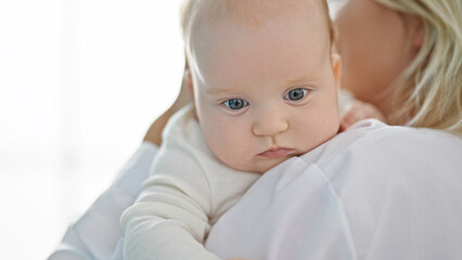 Mother and daughter pediatrician hugging each other at clinic