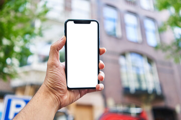 Man holding smartphone showing white blank screen at street