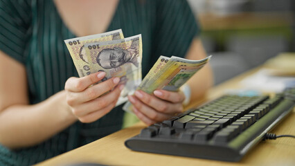 Young redhead woman business worker counting romanian leu banknotes at office