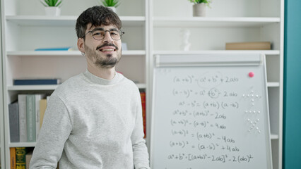 Young hispanic man teacher teaching maths lesson at university classroom