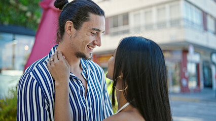 Man and woman couple smiling confident standing together at street