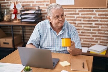 Fototapeta na wymiar Middle age grey-haired man business worker using laptop drinking coffee at office