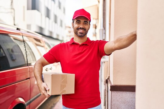 Young Hispanic Man Courier Holding Package Press Doorbell At Street