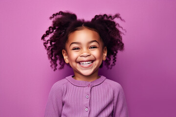 Cute little girl portrait on studio background, smiling child in purple
