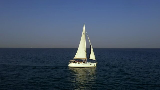 Aerial Panning Shot Of People On Sailing Ship Against Sky At Sunset, Drone Flying Over Sea - Tel Aviv, Israel