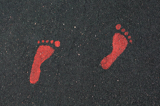 Red human footprints on the floor